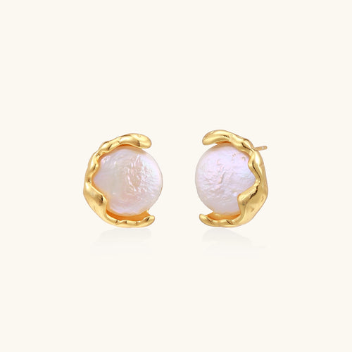 Gold-plated sterling silver stud earrings with organic claw settings cradling lustrous freshwater pearls on white background.