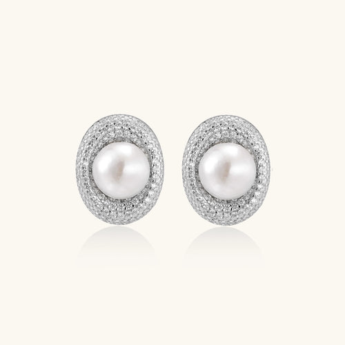 Sterling silver stud earrings with freshwater pearls surrounded by sparkling pavé crystals on white background.