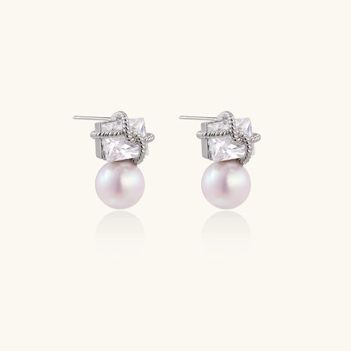 Gold-plated stud earrings with square crystal tops wrapped in twisted wire and freshwater pearl drops on white background