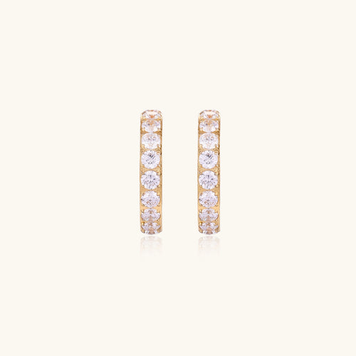 Gold-plated hoop earrings with crystal pavé and floating freshwater pearls inside the circular design.