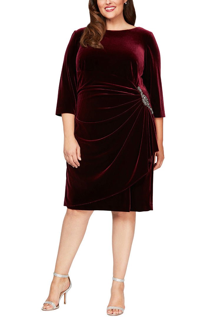 Plus Short Velvet Cocktail Dress with Figure Flattering Side Ruching, Embellishment Detail at Hip and 3/4 Sleeves - alexevenings.com